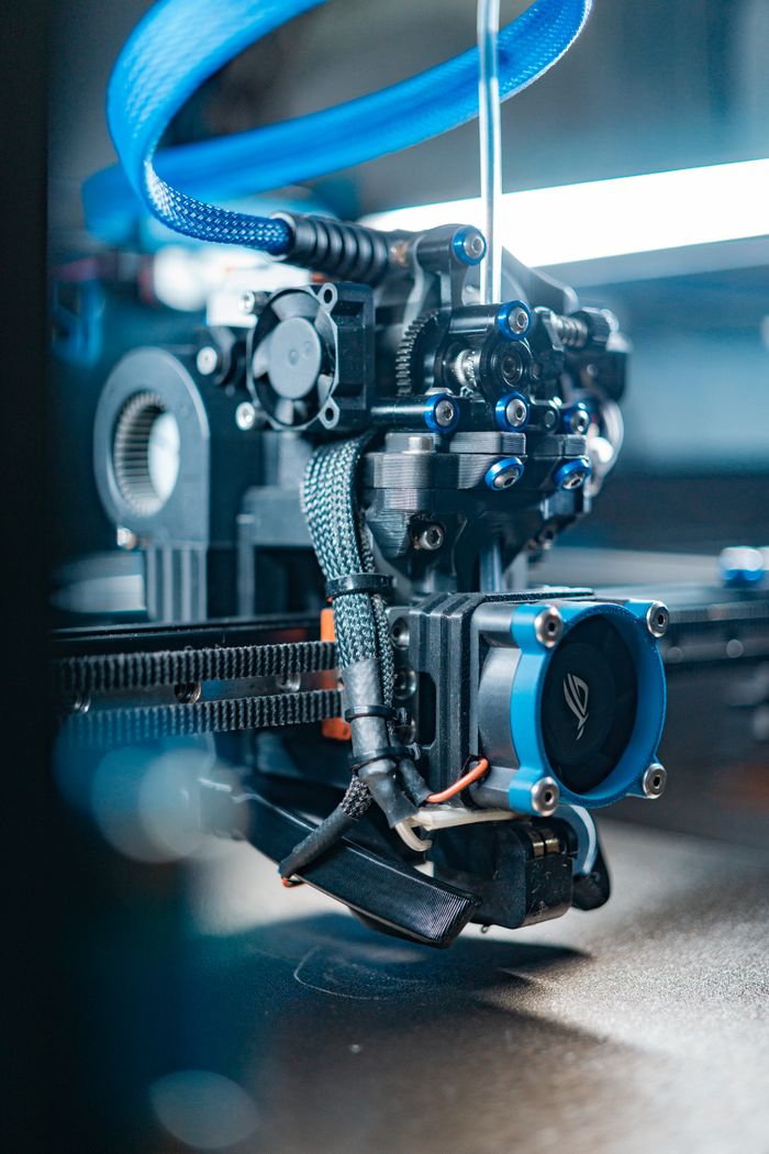 Close-up view of a high-tech 3D printer in operation, capturing detailed mechanics.